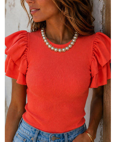 Camiseta Canalé Naranja con Volantes y Collar de Perlas 2